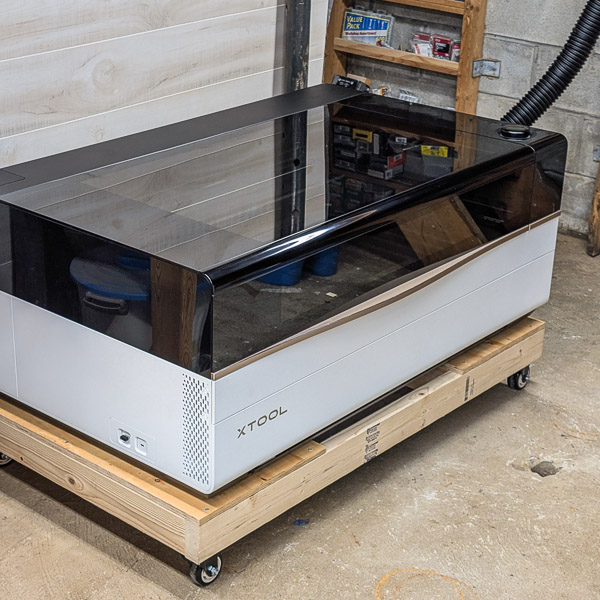 xTool P3 Laser Cutter on a low platform near a concrete floor
