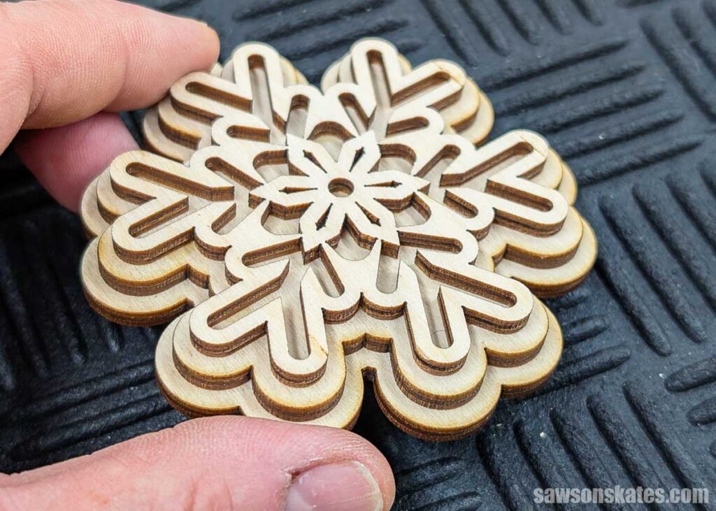 Hand holding a laser cut ornmanet