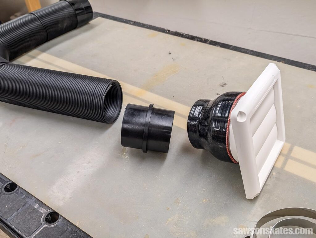 Hose, connector pipe, and vent on a workbench