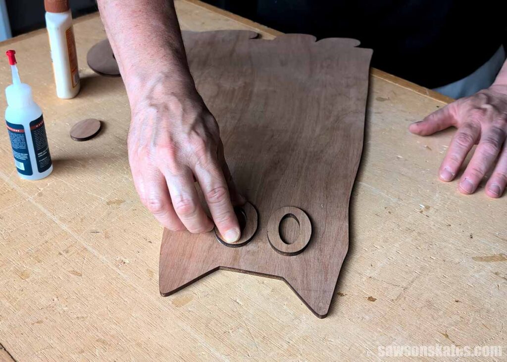 Scott gluing a wooden cat's eye in place
