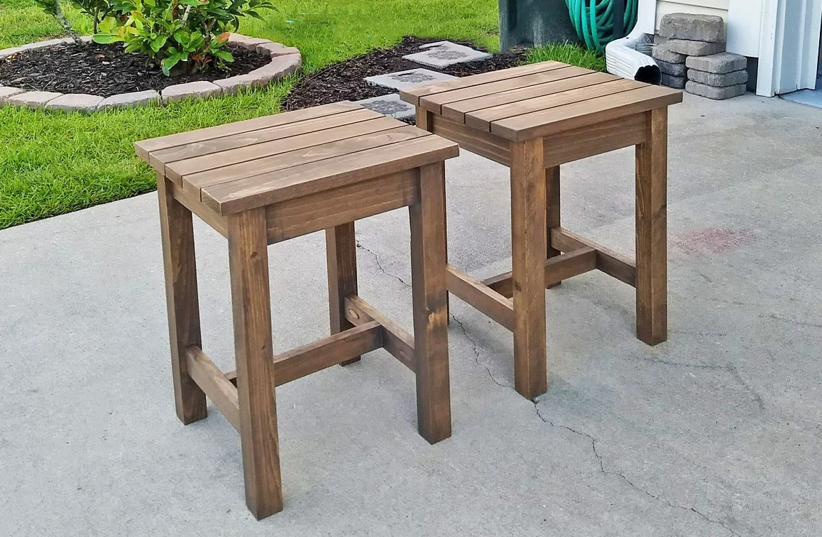 Set of two matching DIY outdoor side tables with slatted tops and square legs.