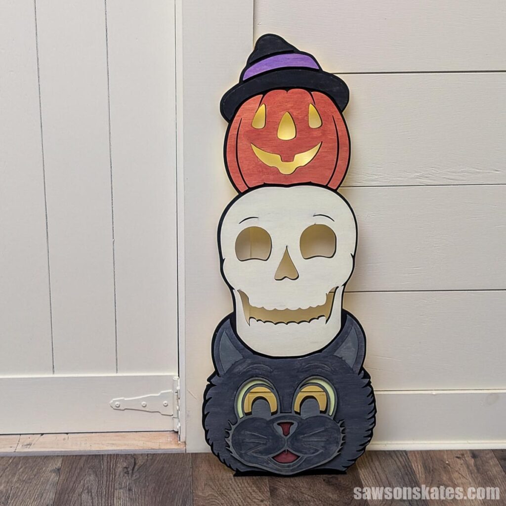 Front view of a Halloween totem with a cat, skull, and jack-o-lantern