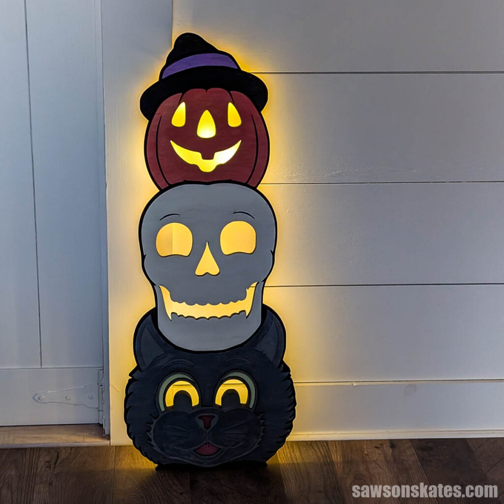 Halloween totem lit up from behind in a dark room