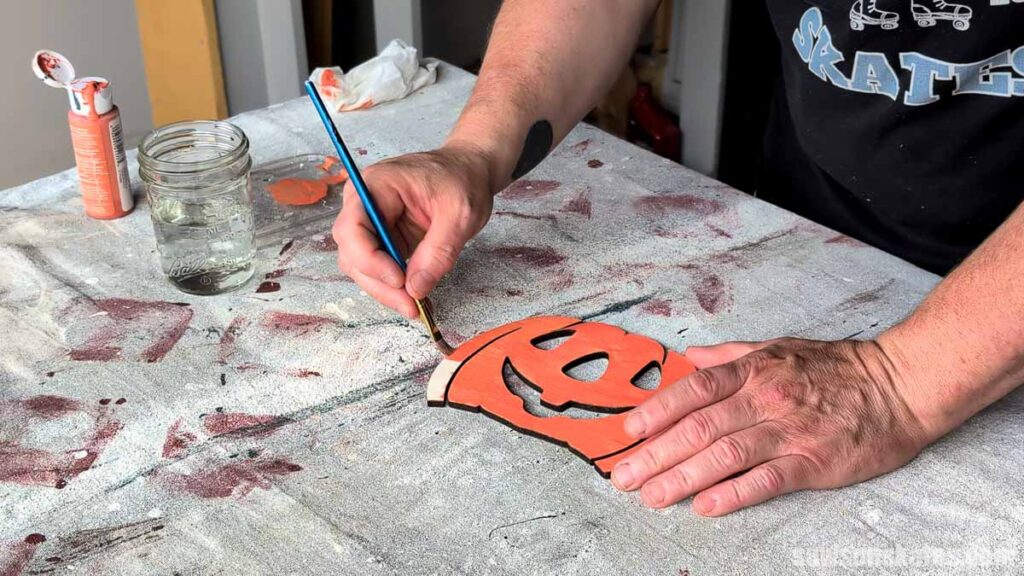 Scott painting a jack-o-lantern