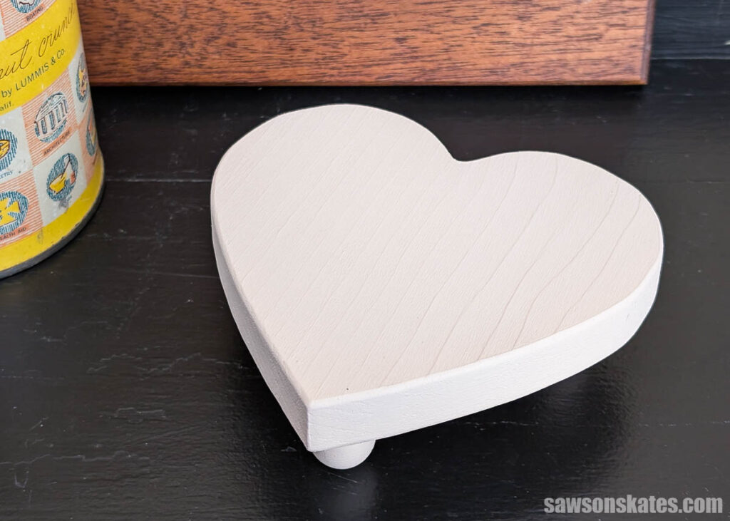 A wood heart-shaped riser on a table