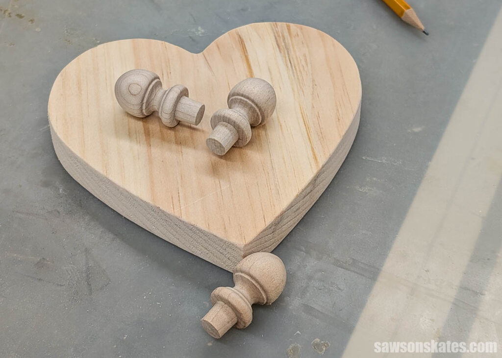 A wood heart shape with three small finials