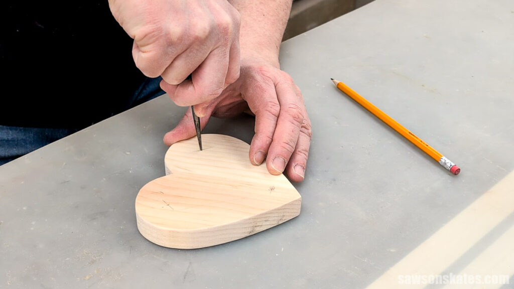 Using an awl to make a starting point for a drill bit