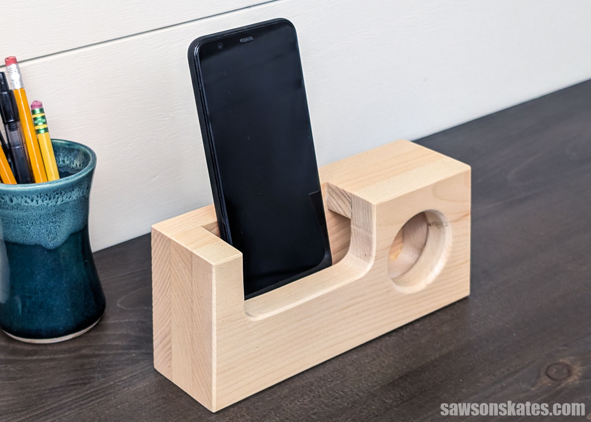 Wood phone amplifier on a table with a cell phone