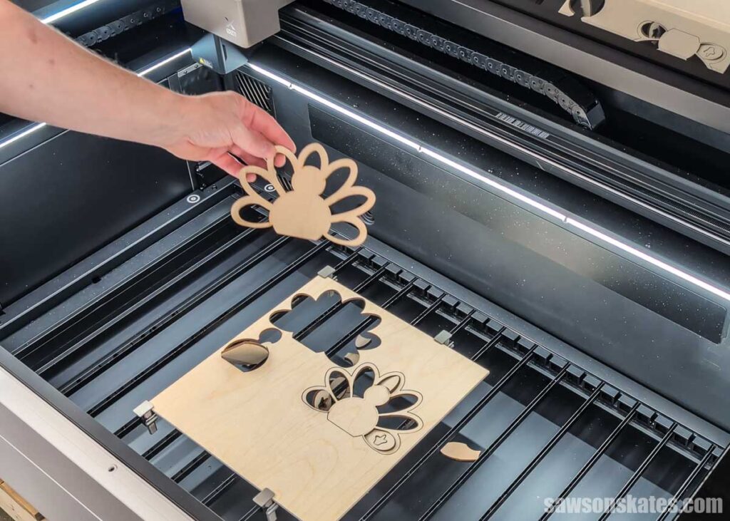 Scott removing a part of the turkey from the laser cutter