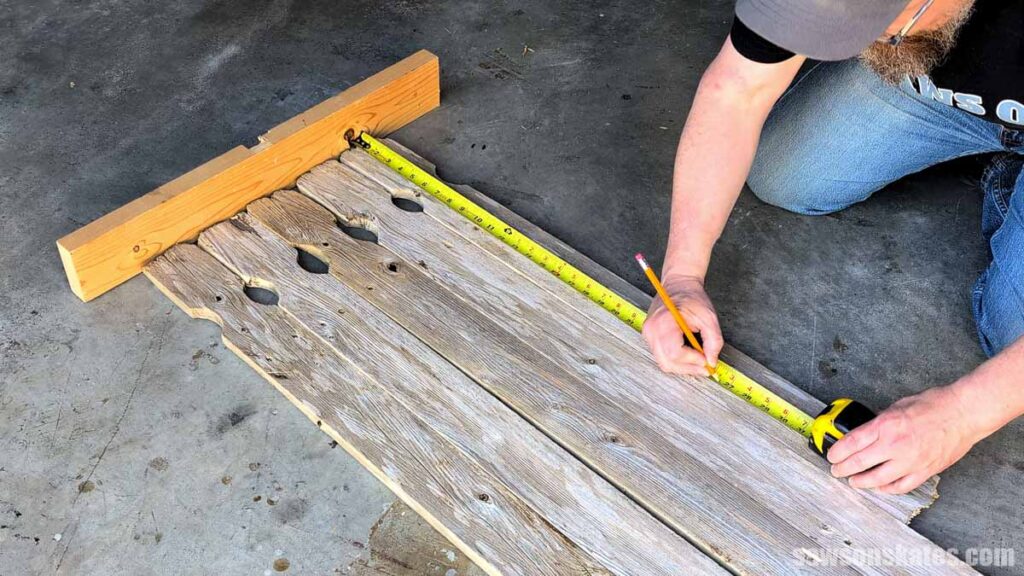 Person marking a group of pickets for length