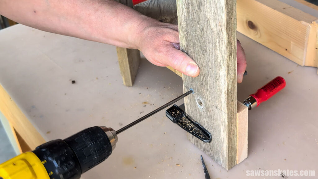 Driving a screw to attach the outer slat.