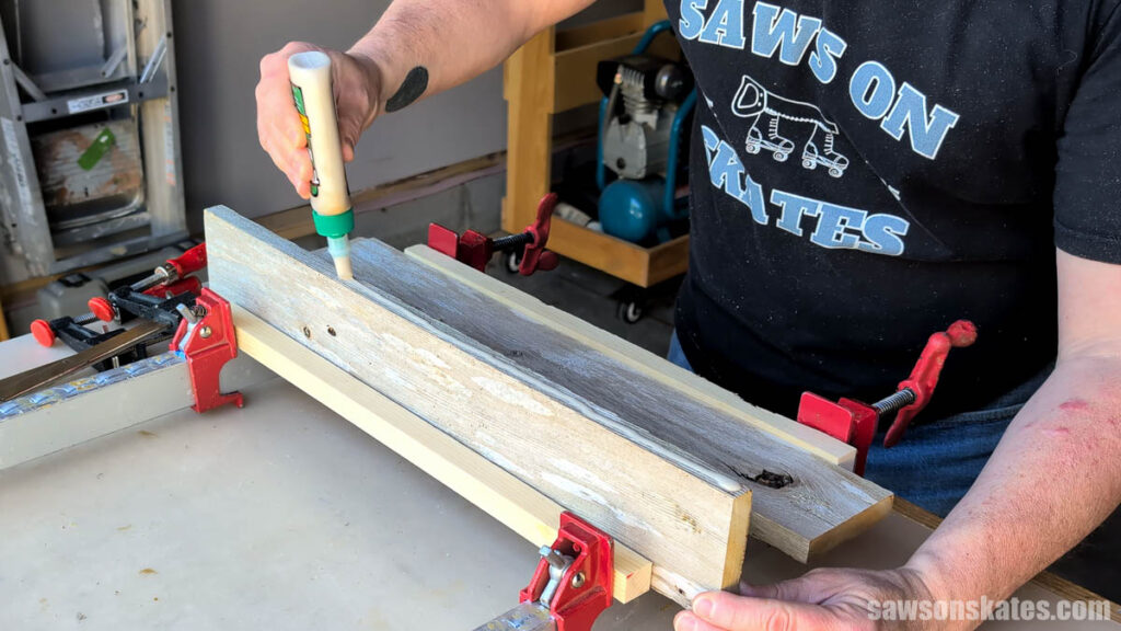 Person applying glue to the edge of a board