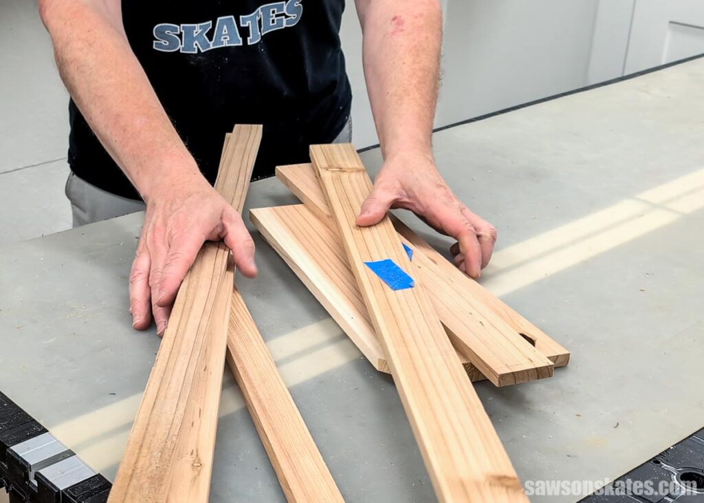Scott placing scrap wood on his workbench