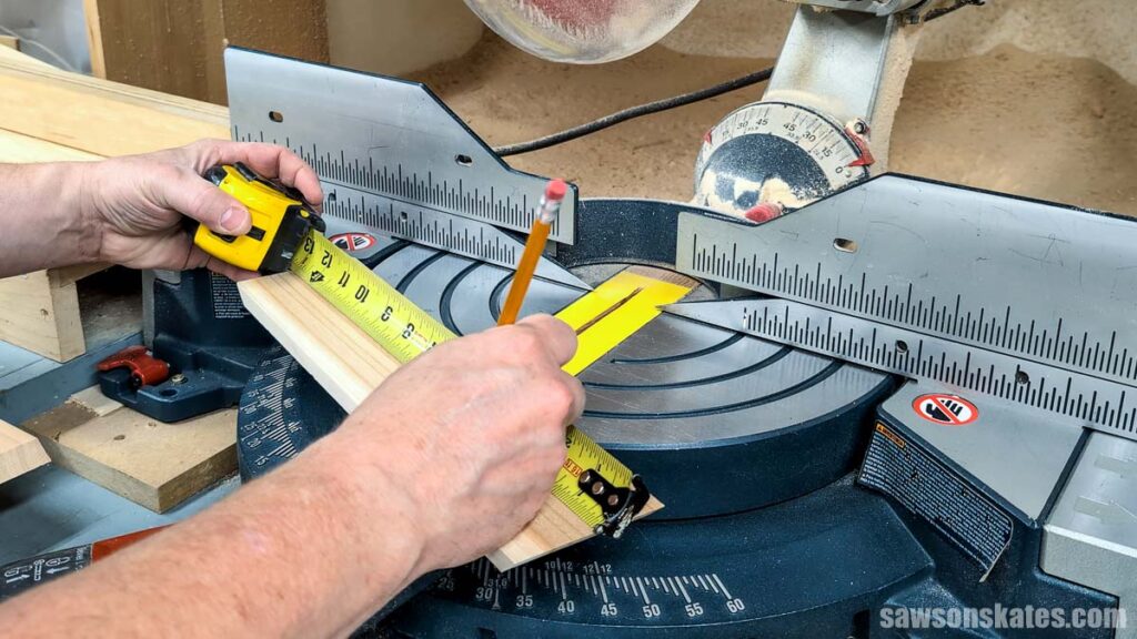 Marking a board for length with tape measure and pencil