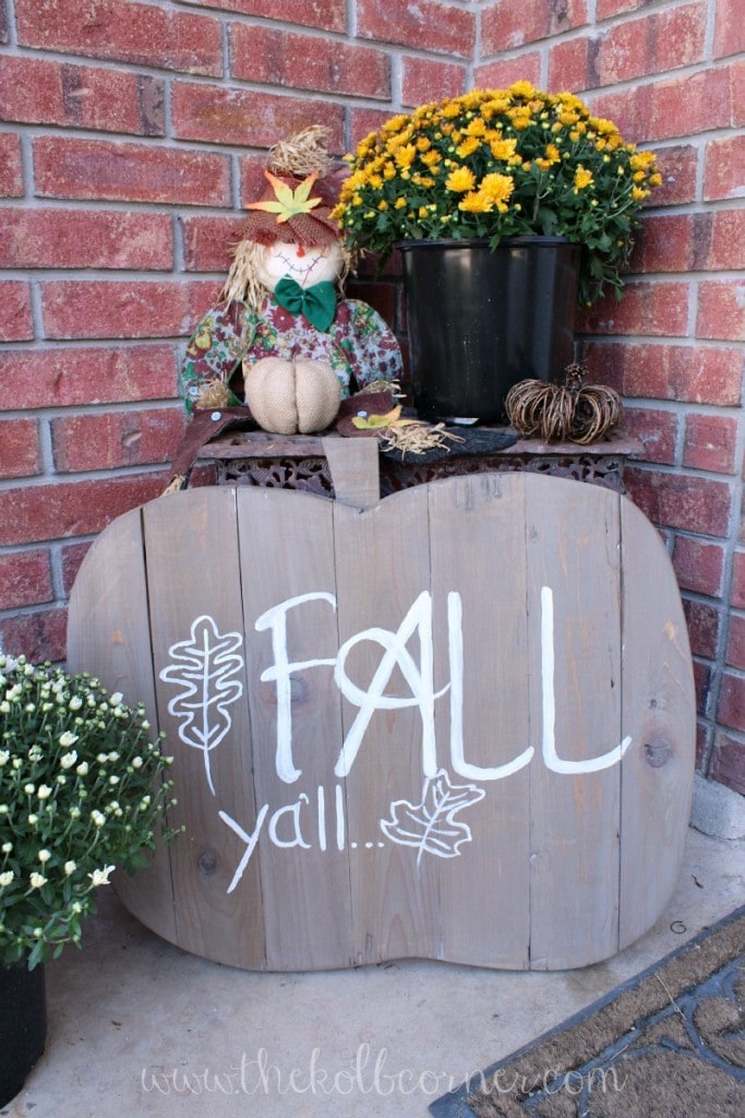 Gray painted wood pumpkin sign that says, Fall Ya'll