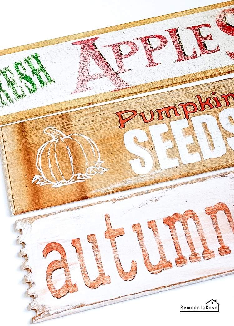 Closeup of three fall wooden signs