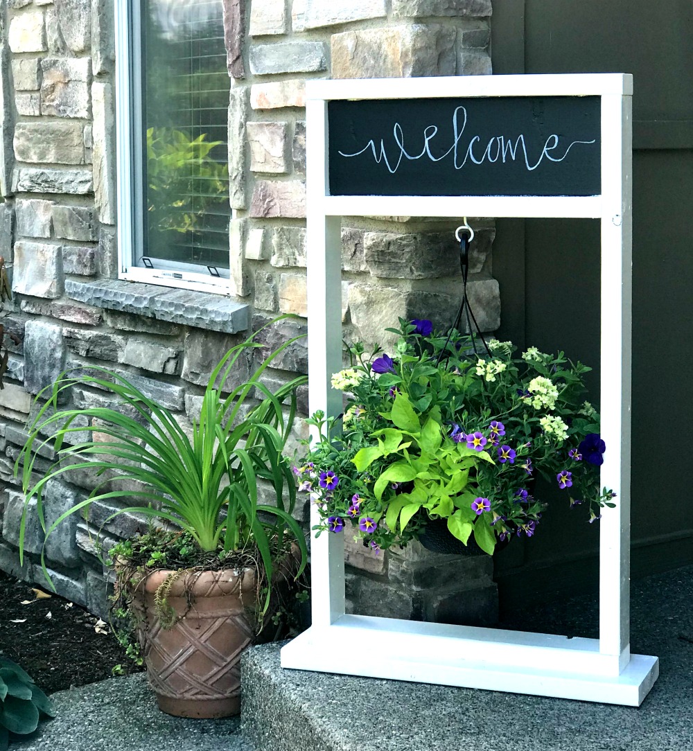 Wooden plant stand with a hanging basket with a chalkboard