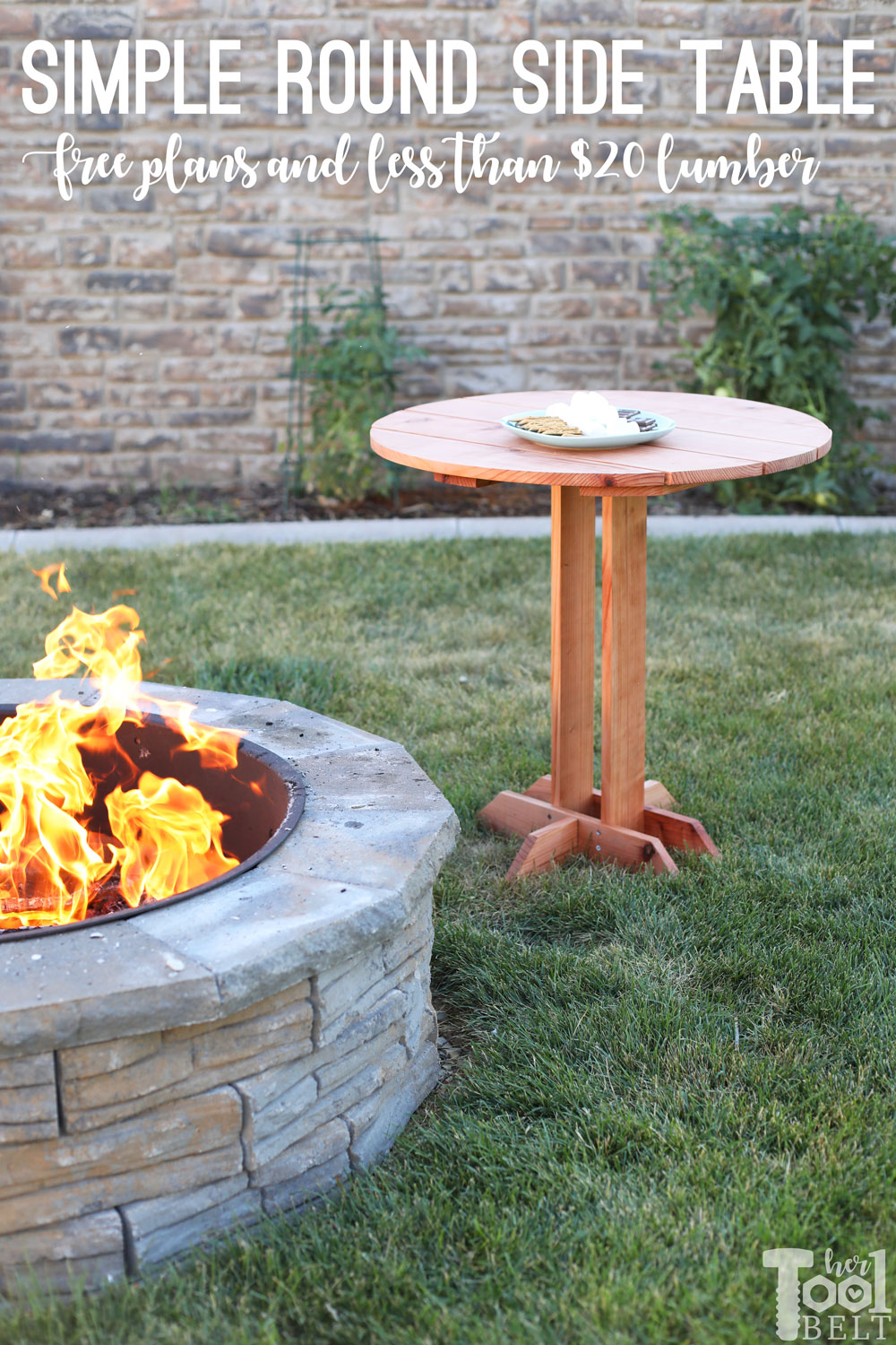 Round wooden outdoor side table with a pedestal-style base stands beside a backyard fire pit.
