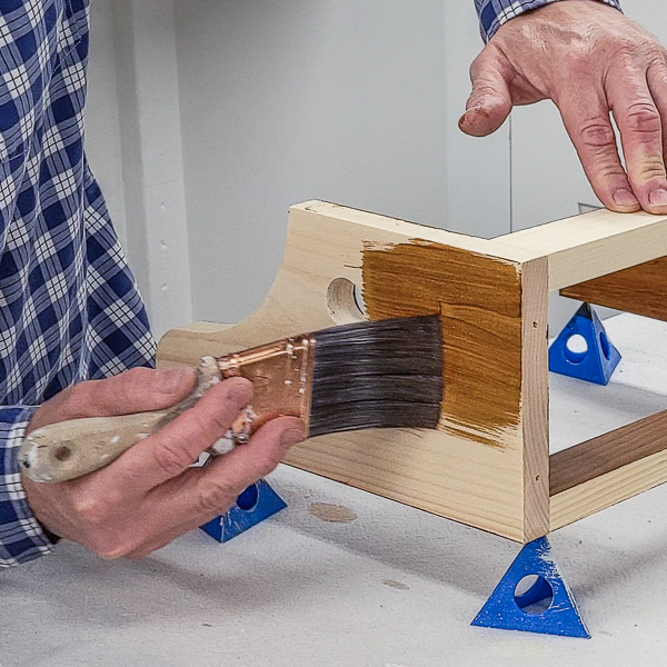 Apply stain to pine with a brush