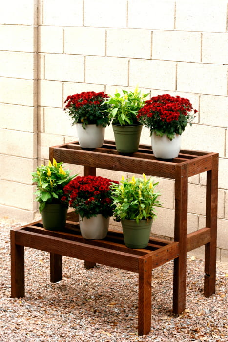 Two-tier wood plant stand with potted mums