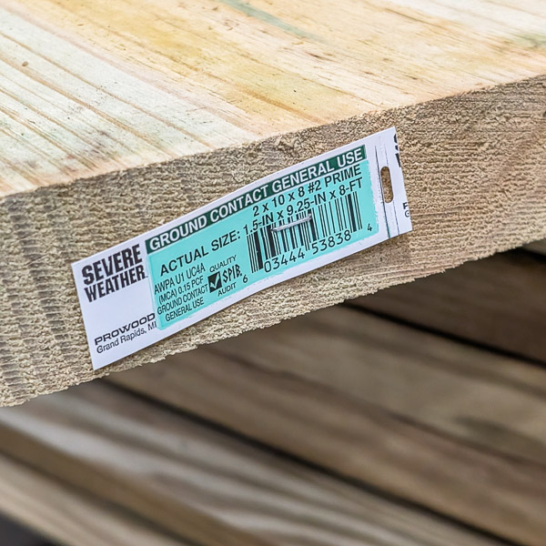 Tag stapled to the end of a pressure treated board